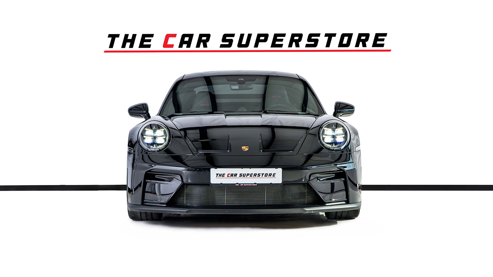 The Car Superstore branded plate holder on a Porsche